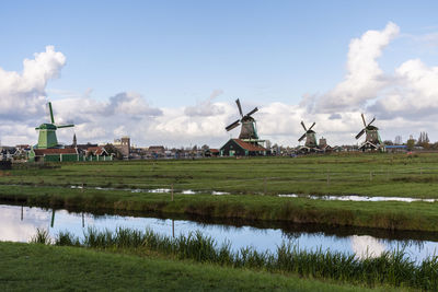 Traditional windmill on field against sky