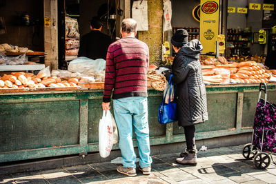 Rear view of people at market stall