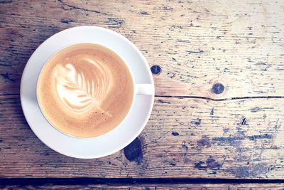 Directly above shot of coffee on wooden table