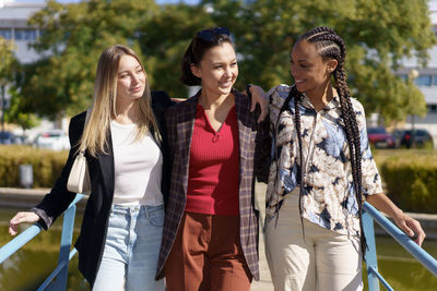 Friends standing against trees