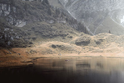 Scenic view of lake with mountain range in background