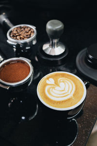 High angle view of cappuccino served on table