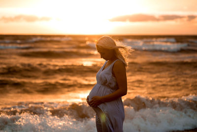 Woman on beach at sunset