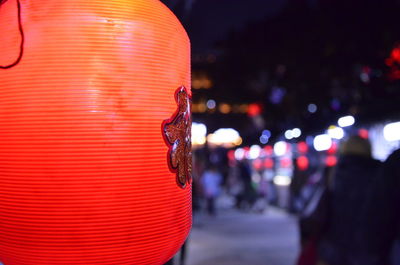 Close-up of illuminated red light painting on street