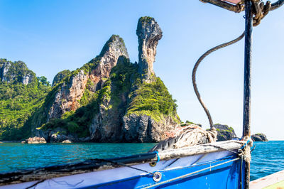 Scenic view of sea and mountains against clear sky