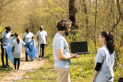 Rear view of woman using digital tablet