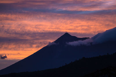 Scenic view of silhouette mountains against sky during sunset