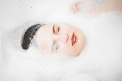 Woman taking bath in bathtub