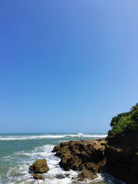 Scenic view of sea against clear blue sky