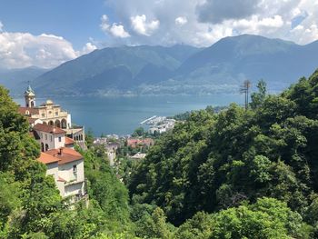 Scenic view of townscape by mountains against sky