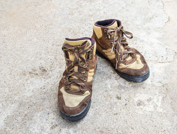 Brown hiking boots on the cement floor