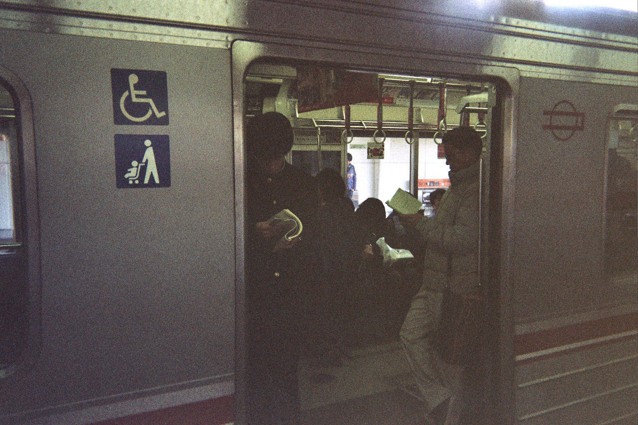 PEOPLE ON TRAIN AT RAILROAD STATION PLATFORM