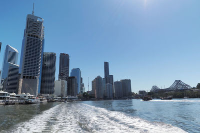 Modern buildings in city against clear sky