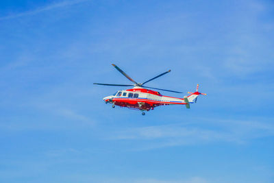 Low angle view of helicopter flying against clear sky
