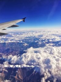 Aerial view of mountains against blue sky