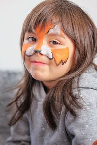 Close-up of little girl with fox face paint 