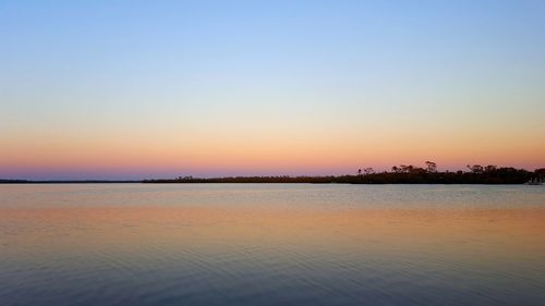 Scenic view of sea against clear sky during sunset
