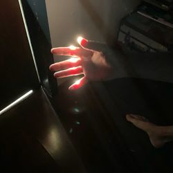 High angle view of person touching illuminated light