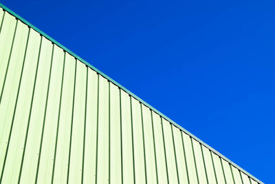 Perspective of building against clear blue sky background 