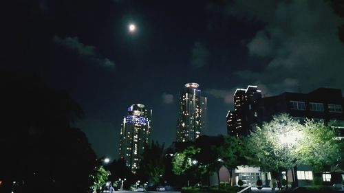 Illuminated city against sky at night