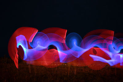 Illuminated light painting against black background