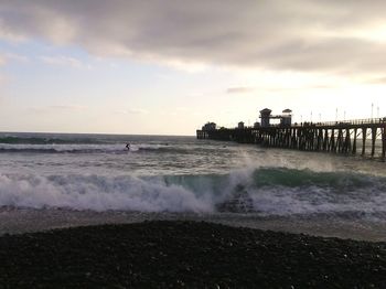 Scenic view of sea against cloudy sky