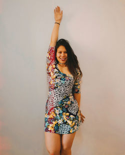 Portrait of woman standing against white background