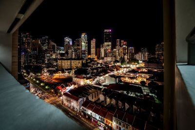 Aerial view of illuminated buildings in city at night