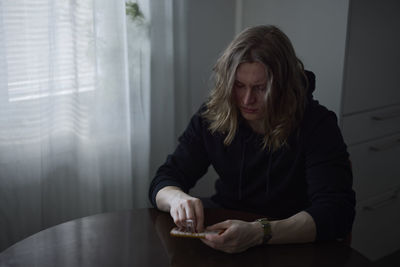 Sad woman holding pill box