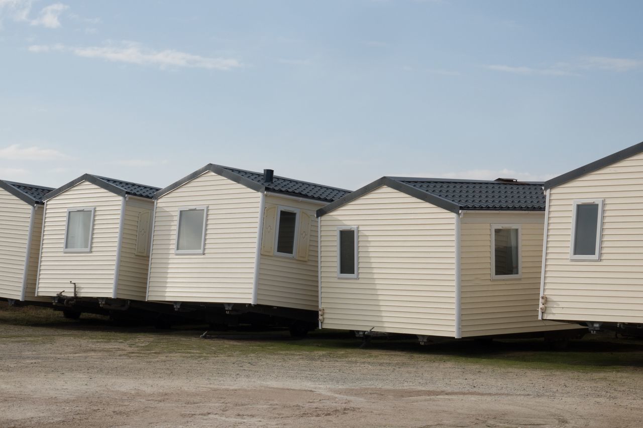 building exterior, built structure, architecture, sky, cloud - sky, building, day, nature, outdoors, no people, house, residential district, grass, transportation, window, in a row, land, beach hut, mode of transportation, hut, garage