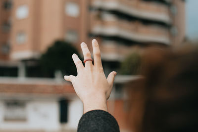 Midsection of woman with arms raised