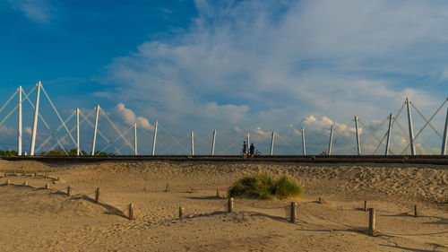 Panoramic view of wind turbines on land against sky