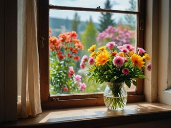 Close-up of flowers on window