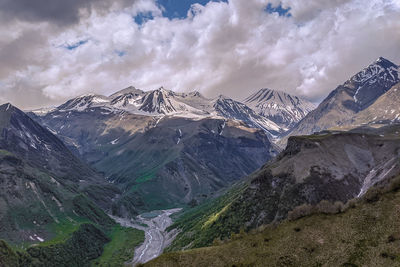 Panoramic view of snowcapped mountains against sky