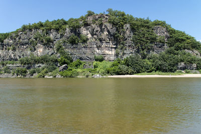 Scenic view of river by trees against clear sky