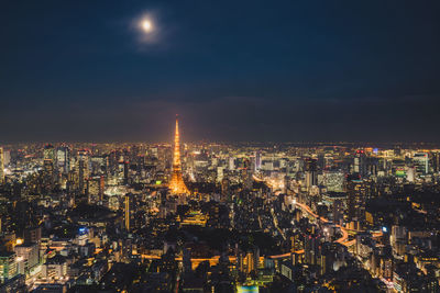 High angle view of illuminated buildings against sky at night