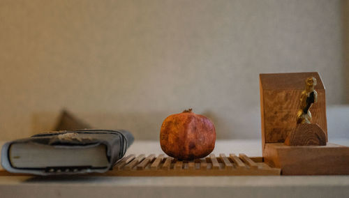 Close-up of apples on table against wall