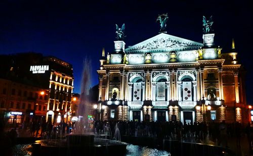 Illuminated buildings in city at night