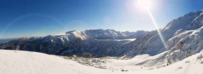 Scenic view of snowcapped mountains against sky