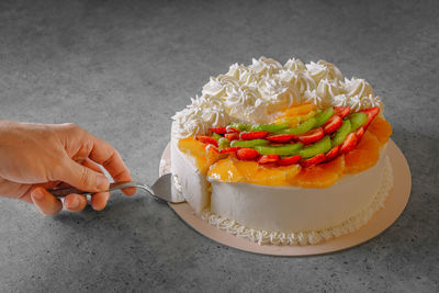 Cropped hand of person holding food