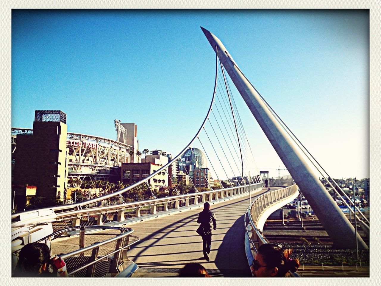 transfer print, built structure, architecture, clear sky, men, auto post production filter, city, copy space, building exterior, lifestyles, leisure activity, blue, transportation, bridge - man made structure, person, travel destinations, capital cities, city life, connection