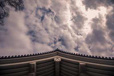 Low angle view of building against cloudy sky