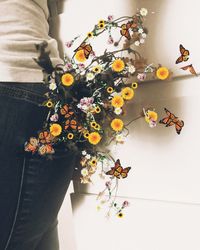 Close-up of woman standing by flowering plant