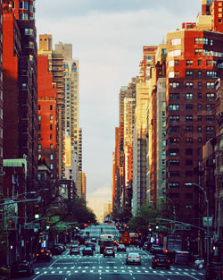 Traffic on city street and buildings against sky