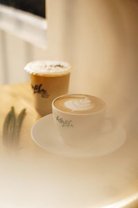 High angle view of coffee cups on table