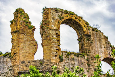 Low angle view of old ruins against sky