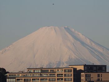 Buildings in city against clear sky