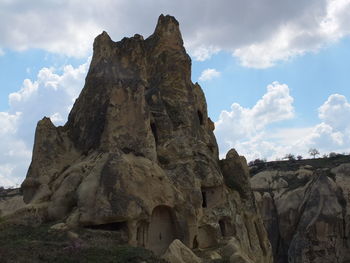 Low angle view of rock formation against sky