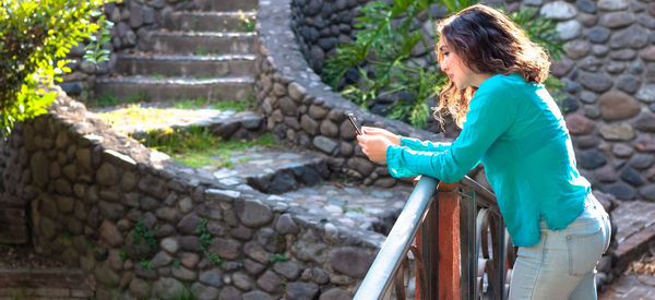 Side view of woman holding umbrella