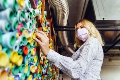 Low angle view of young woman standing at factory